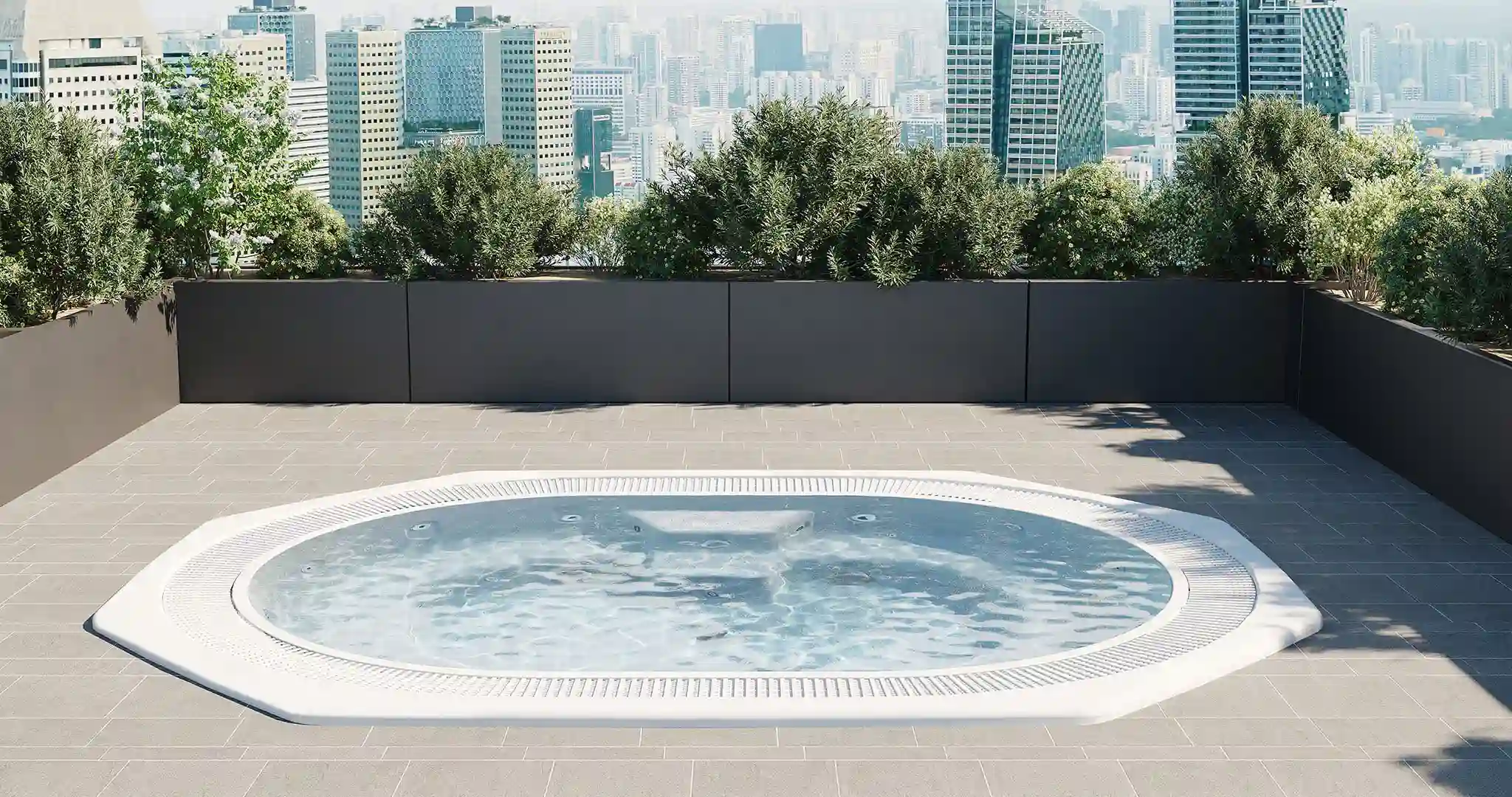 A sleek acrylic infinity-edge hot tub installed at a luxury Caribbean hotel, surrounded by tropical plants and ocean views.