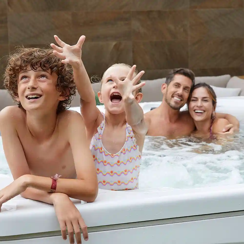 6 people hot tub with ambient lighting and bubbling water in backyard